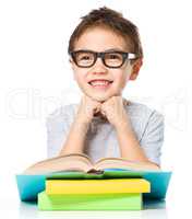 Little boy is reading a book