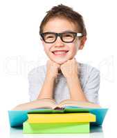 Little boy is reading a book