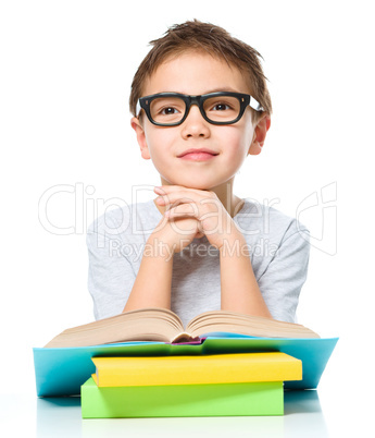 Little boy is reading a book