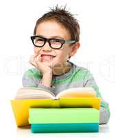 Little boy is reading a book