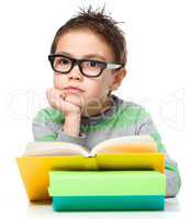 Little boy is reading a book