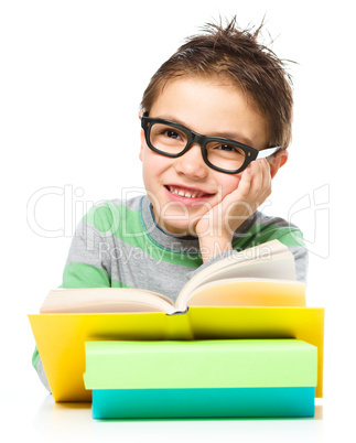 Little boy is reading a book