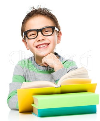 Little boy is reading a book