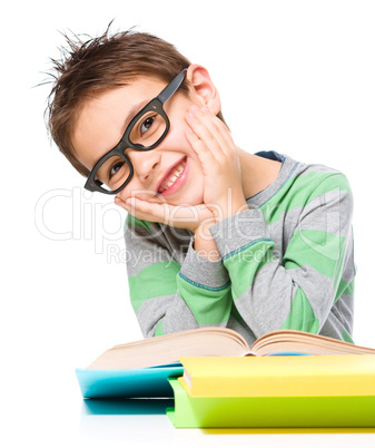 Little boy is reading a book