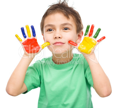 Portrait of a cute boy playing with paints