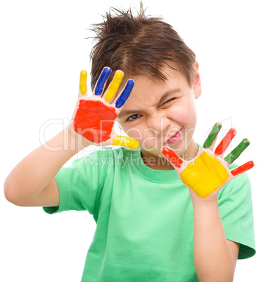 Portrait of a cute boy playing with paints