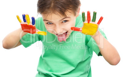 Portrait of a cute boy playing with paints