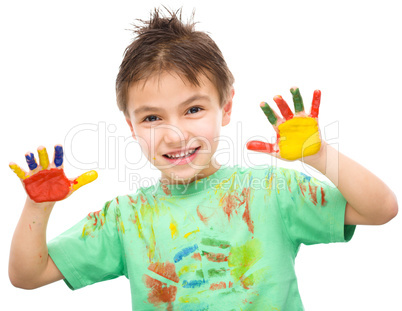 Portrait of a cute boy playing with paints