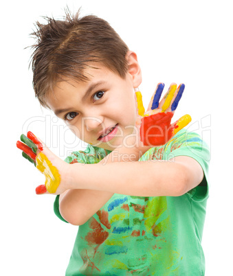 Portrait of a cute boy playing with paints