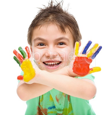 Portrait of a cute boy playing with paints