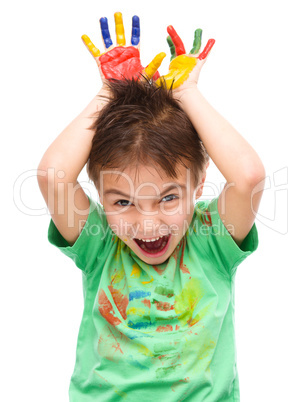 Portrait of a cute boy playing with paints