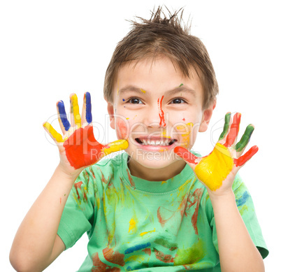 Portrait of a cute boy playing with paints