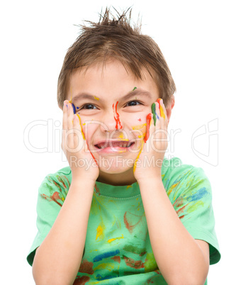 Portrait of a cute boy playing with paints