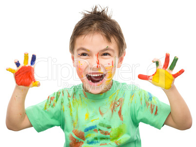 Portrait of a cute boy playing with paints