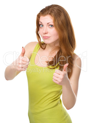 Woman is showing thumb up gesture