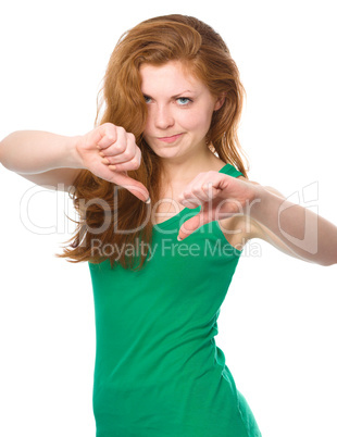 Woman is showing thumb down gesture