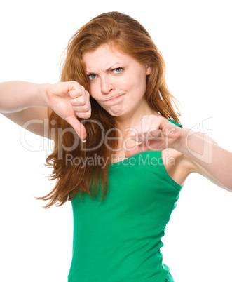 Woman is showing thumb down gesture