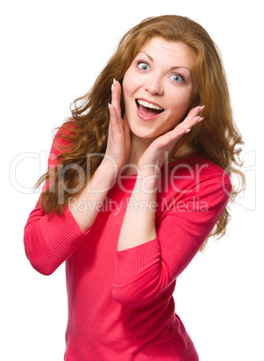 Woman is holding her face in astonishment