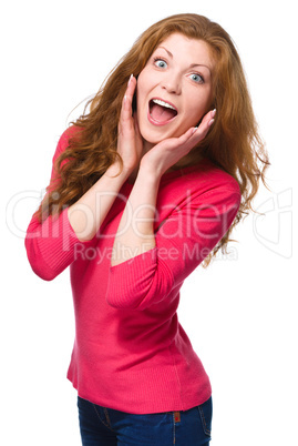 Woman is holding her face in astonishment