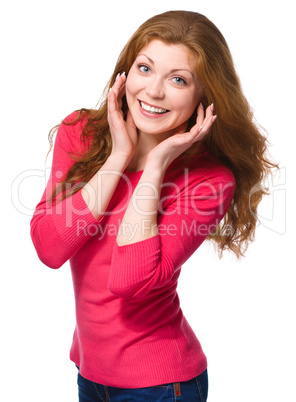 Woman is holding her face in astonishment