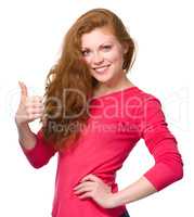 Woman is showing thumb up gesture