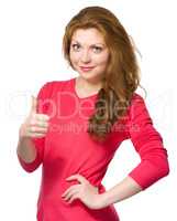 Woman is showing thumb up gesture