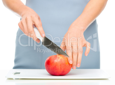 Cook is chopping apple