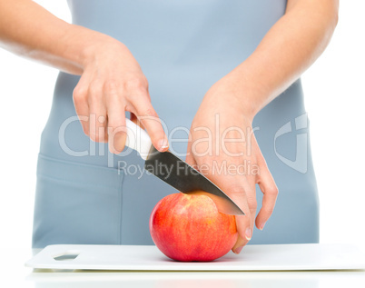 Cook is chopping apple