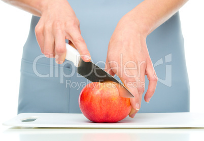 Cook is chopping apple