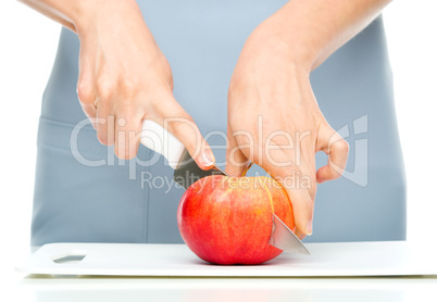 Cook is chopping red apple Cook is chopping red apple