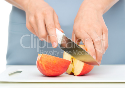 Cook is chopping apple