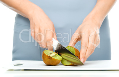 Cook is chopping kiwi fruit