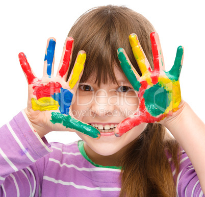 Portrait of a cute girl playing with paints