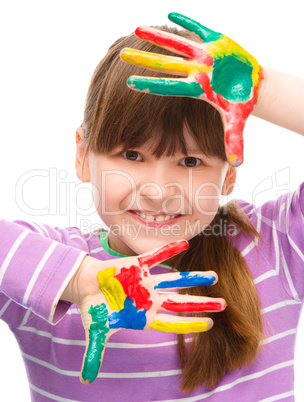 Portrait of a cute girl playing with paints