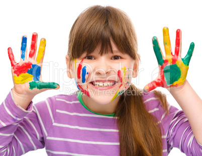 Portrait of a cute girl playing with paints