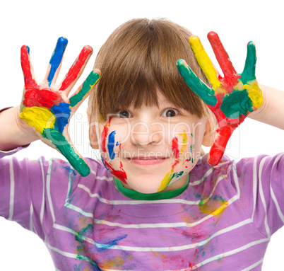 Portrait of a cute girl playing with paints