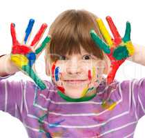 Portrait of a cute girl playing with paints