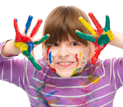 Portrait of a cute girl playing with paints