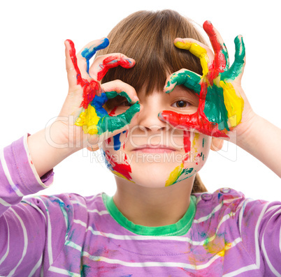 Portrait of a cute girl playing with paints