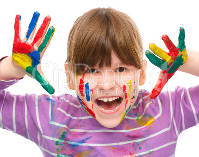 Portrait of a cute girl playing with paints