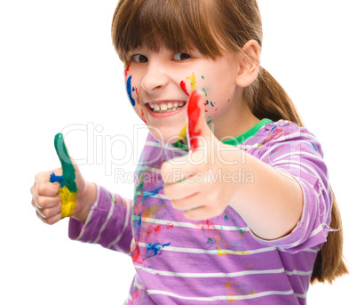 Portrait of a cute girl playing with paints