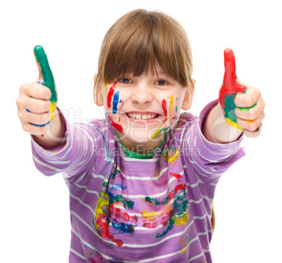 Portrait of a cute girl playing with paints