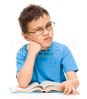 Little boy is tired to read his book