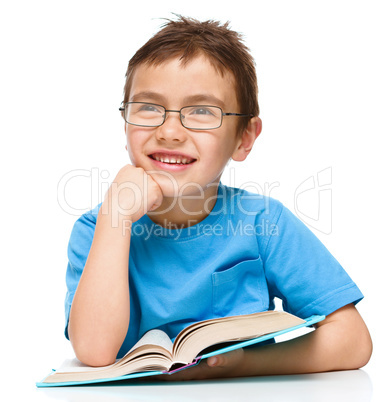 Little boy is reading a book