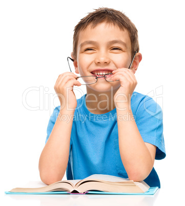 Little boy is reading a book