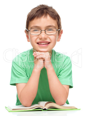 Little boy is reading a book