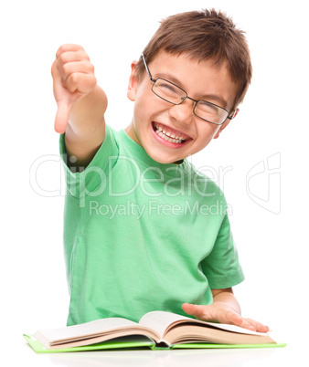 Little boy is reading a book