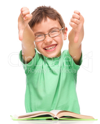 Little boy is reading a book