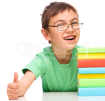 Little boy is reading a book