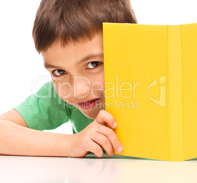 Little boy plays with book